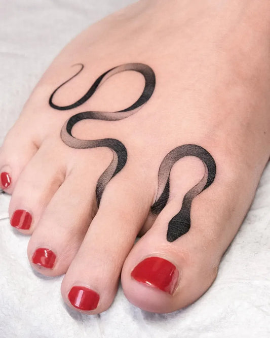 Small Black and Grey Snake Tattoo on Women Foot by @blxckink