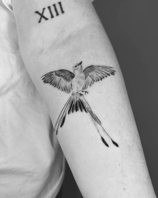 Small Black and Grey Sparrow Tattoo on Men Arm by @eian.tatt