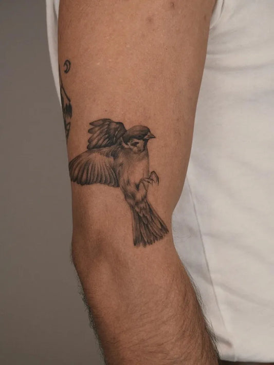 Small Black and Grey Sparrow Tattoo on Men Arm by @reyhanbeyenirsoy