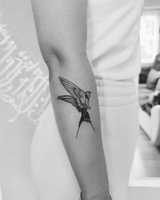 Small Black and Grey Sparrow Tattoo on Women Arm by @_saturn_symetry_
