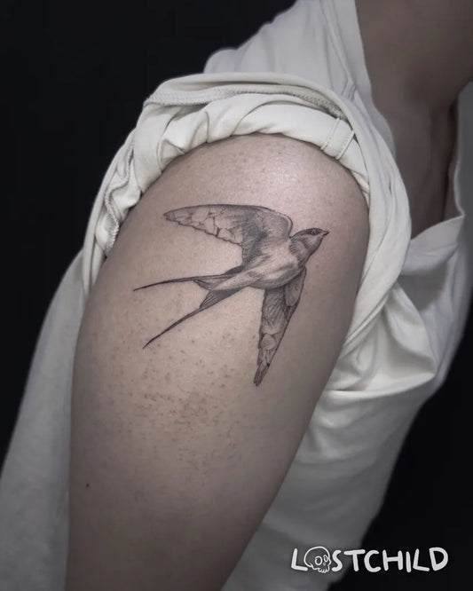 Small Black and Grey Sparrow Tattoo on Women Upper Arm by @bird_lostchild