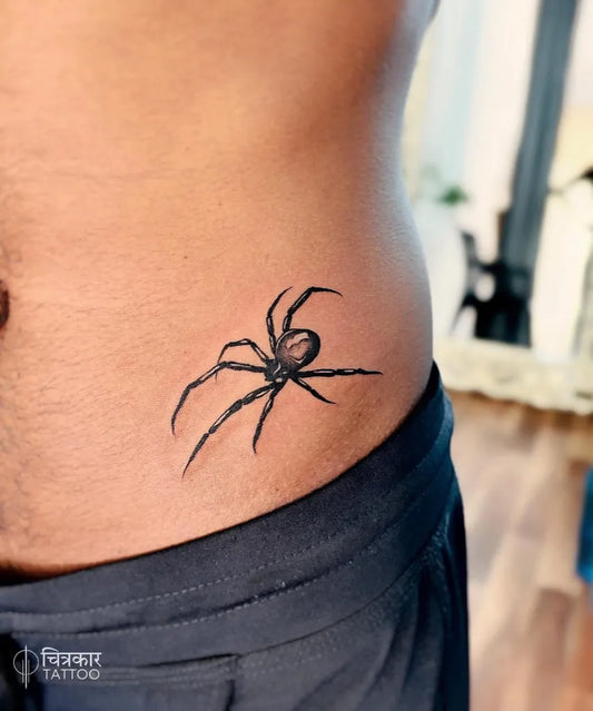 Small Black and Grey Spider on Men Torso Tattoo by @chitrakaartattoo