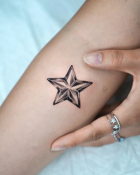 Small Black and Grey Star Tattoo on Women Arm by @q.lee_tattoo