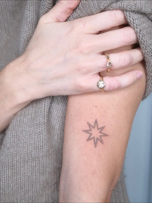 Small Black and Grey Star Tattoo on Women Arm by @tatuaggibrutti.tattoo
