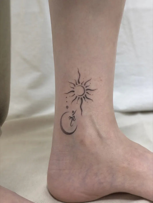Small Black and Grey Sun Moon Dancer on Women Ankle Tattoo by @namaste_poke