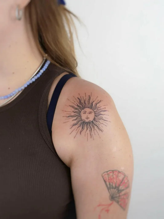 Small Black and Grey Sun and Fan on Women Shoulder Tattoo by @gusef.doga