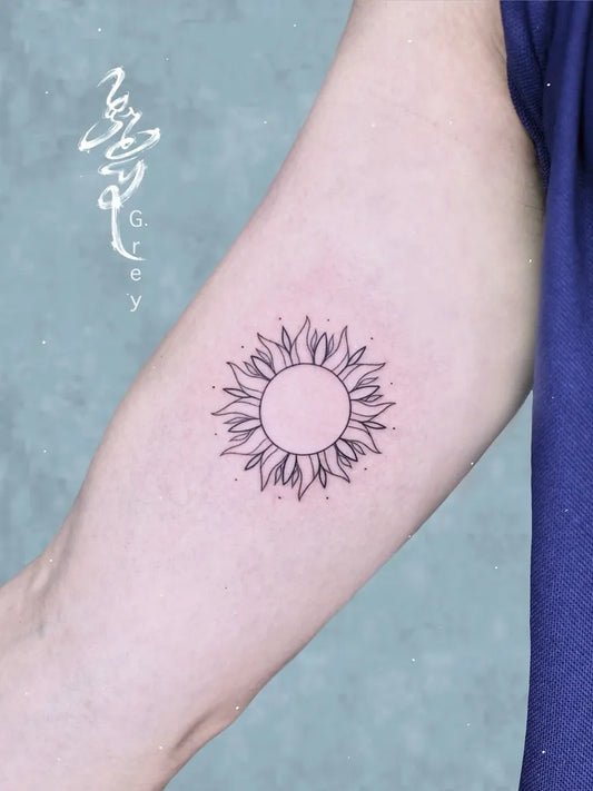 Small Black and Grey Sun on Women Arm Tattoo by @grey3110.tattooist