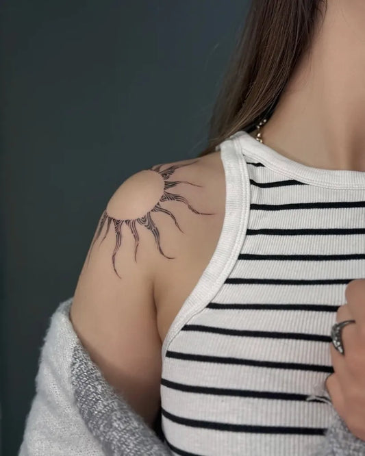 Small Black and Grey Sun on Women Shoulder Tattoo by @darrya_tattooo