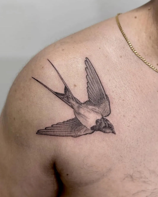 Small Black and Grey Swallow Tattoo on Men Shoulder by @lindt.ink