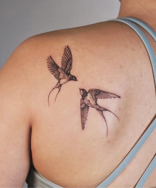 Small Black and Grey Swallow Tattoo on Women Shoulder by @soulpurposetattoo