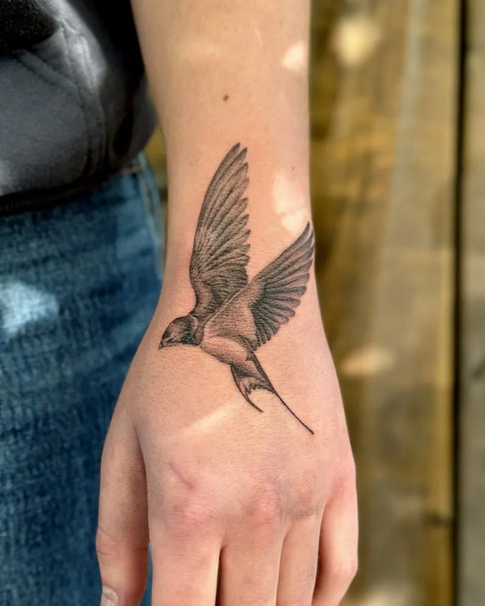 Small Black and Grey Swallow Tattoo on Women Wrist by @khk.ttt