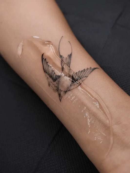 Small Black and Grey Swallow Tattoo on Women Wrist by @sashatretiakov_