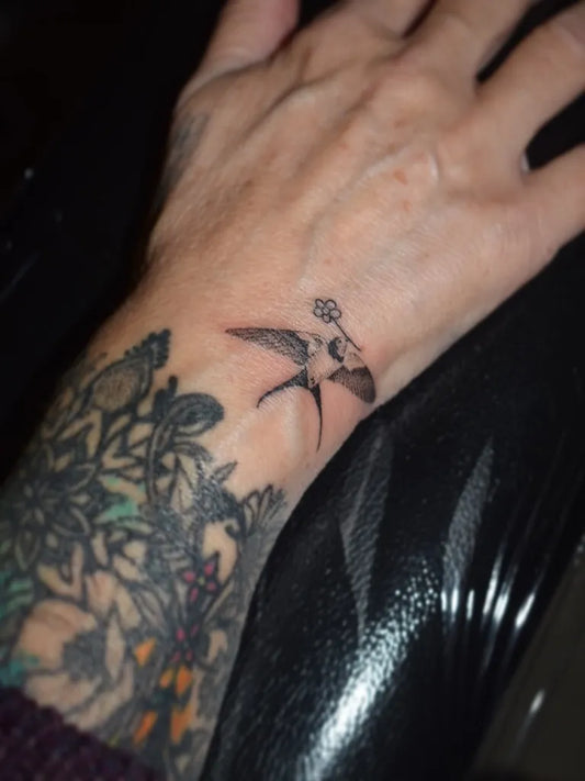 Small Black and Grey Swallow Tattoo on Women Wrist by @vicknpoke
