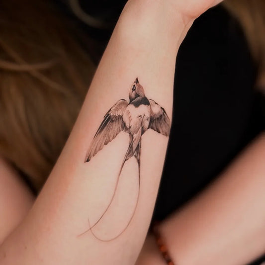 Small Black and Grey Swallow Tattoo on Women Wrist by @yuta.tatt