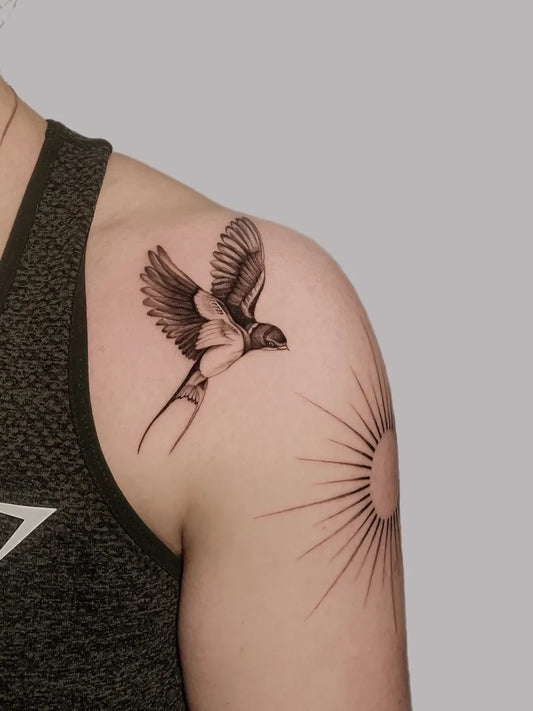 Small Black and Grey Swallow and Sun Tattoo on Women Shoulder by @claudiablont_tattoo