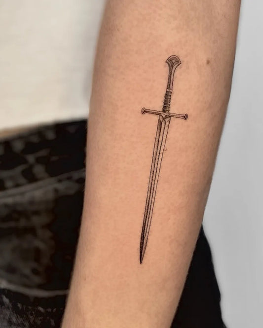 Small Black and Grey Sword on Women Arm Tattoo by @obscura.tattoo