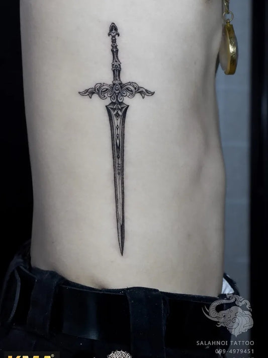 Small Black and Grey Sword on Women Side Tattoo by @salahnoi_tattoo