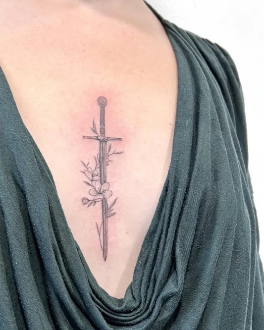 Small Black and Grey Sword with Flowers on Women Chest Tattoo by @tattoobyjulie