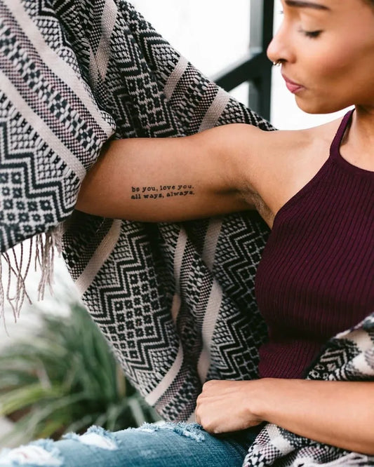 Small Black and Grey Text Quote Tattoo on Women Arm by @the_deanadavis