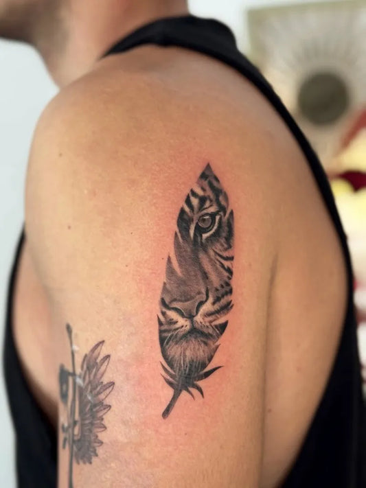 Small Black and Grey Tiger Feather Tattoo on Men Shoulder by @deni_tat.to.love
