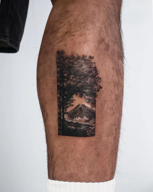 Small Black and Grey Tree and Mountain Tattoo on Men Leg by @zeya.tattoo