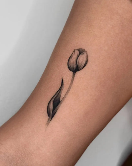 Small Black and Grey Tulip Tattoo on Women Arm by @brunoelargos