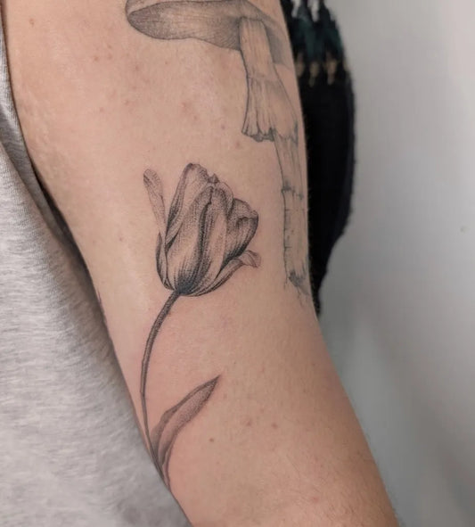 Small Black and Grey Tulip Tattoo on Women Arm by @die_monde