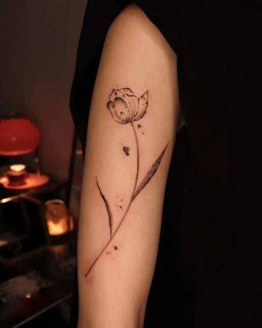 Small Black and Grey Tulip Tattoo on Women Arm by @shudrawsthings