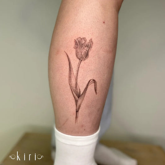 Small Black and Grey Tulip Tattoo on Women Leg by @kiri.vrs