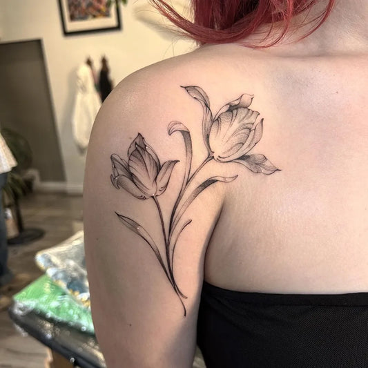 Small Black and Grey Tulips Tattoo on Women Shoulder by @sarararah_tattoos