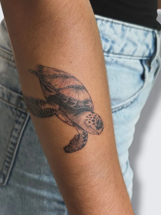 Small Black and Grey Turtle Tattoo on Women Arm by @eth.ink