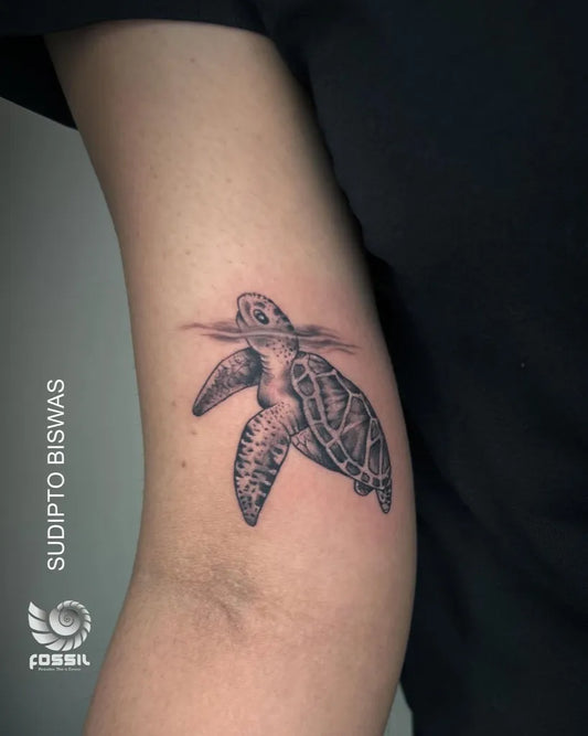 Small Black and Grey Turtle Tattoo on Women Arm by @fossil_tattoo_and_art_studio