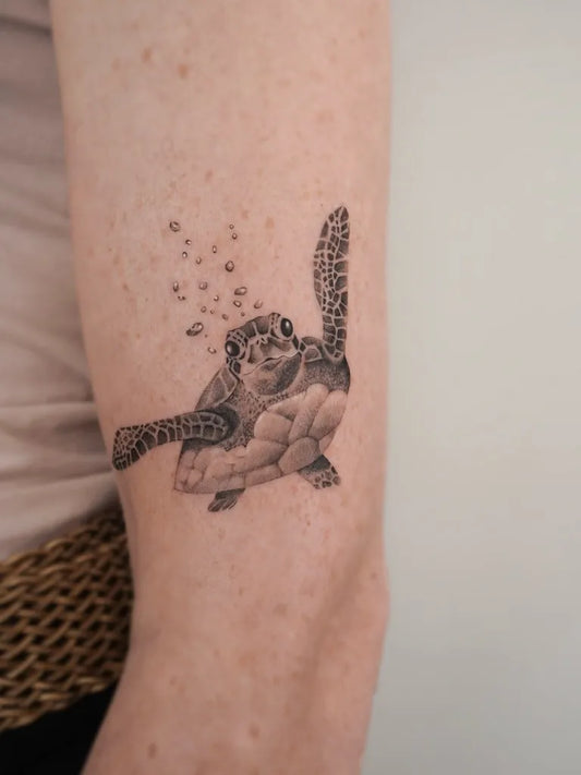 Small Black and Grey Turtle Tattoo on Women Arm by @skylash.ink