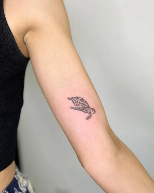 Small Black and Grey Turtle Tattoo on Women Arm by @vampyrotattoo