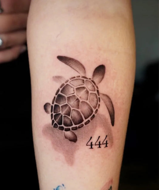 Small Black and Grey Turtle with 444 Tattoo on Women Forearm by @orpheustattoo