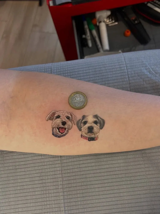 Small Black and Grey Two Dogs Tattoo on Women Arm by @mandetattoos