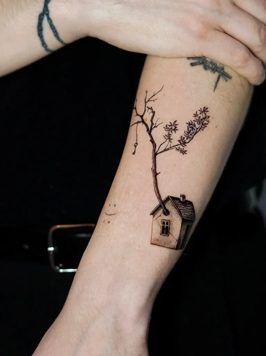 Small Black and Grey Upside Down Tree with House Tattoo on Women Arm by @bekk.inky