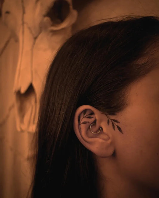 Small Black and Grey Vine Tattoo on Women Behind the Ear by @mastika.tattoo
