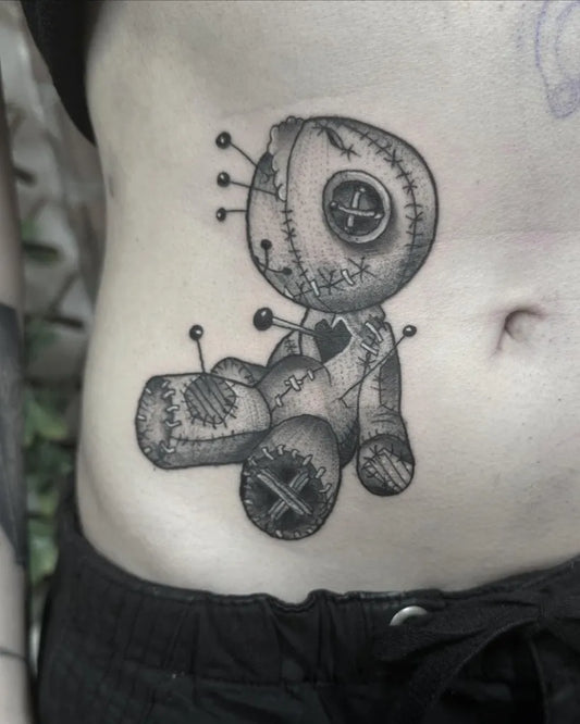 Small Black and Grey Voodoo Doll Tattoo on Women Stomach by @antclaytattoo