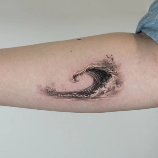 Small Black and Grey Wave Tattoo on Women Arm by @trysics_tattoo