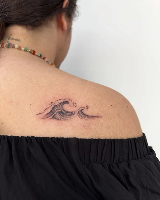 Small Black and Grey Wave Tattoo on Women Shoulder by @muchttoomuch