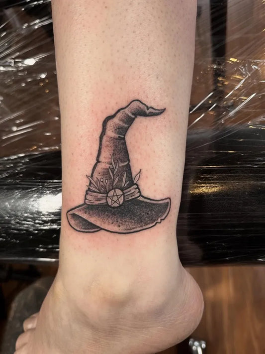 Small Black and Grey Witch Hat Halloween Tattoo on Women Ankle by @toby_everyday_tattoo
