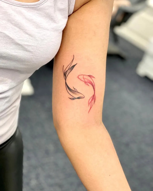 Small Black and Red Yin Yang Koi FishTattoo on Women Arm by @inksane_tattoostudio