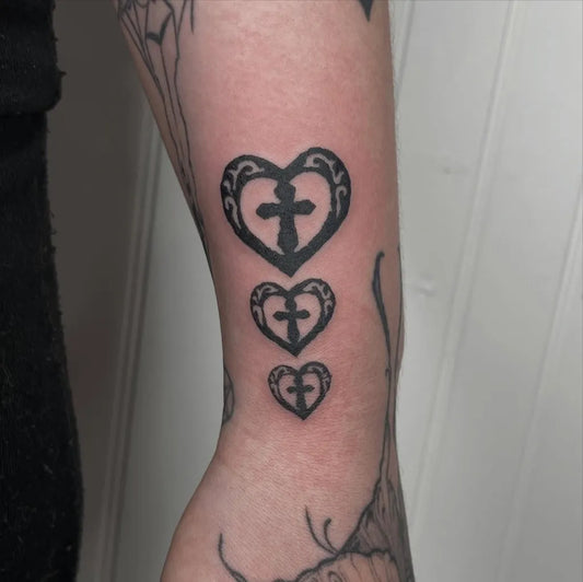 Small Blackwork 3 Cross and Heart Tattoo on Women Arm by @milkyy.strawberryy