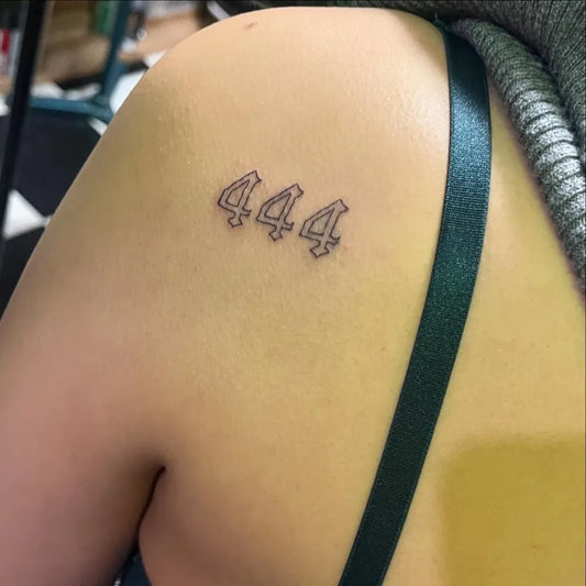 Small Blackwork 444 on Women Shoulder Tattoo by @atomictattoo_studio