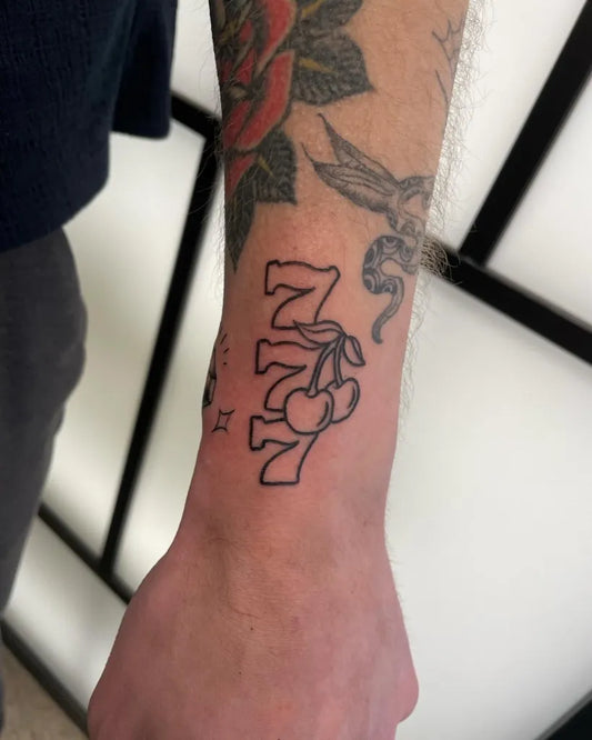 Small Blackwork 777 Cherries Outline Tattoo on Men Wrist by @bigsmokeink