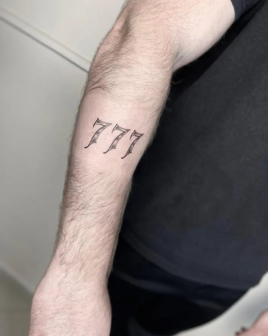 Small Blackwork 777 Tattoo on Men Arm by @manupropria.tattooandpiercing