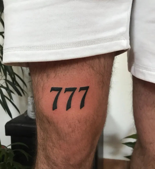 Small Blackwork 777 Tattoo on Men Thigh by @dor.ink