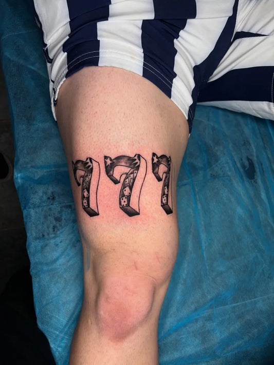 Small Blackwork 777 Tattoo on Men Thigh by @homegrowntattoocoron2023
