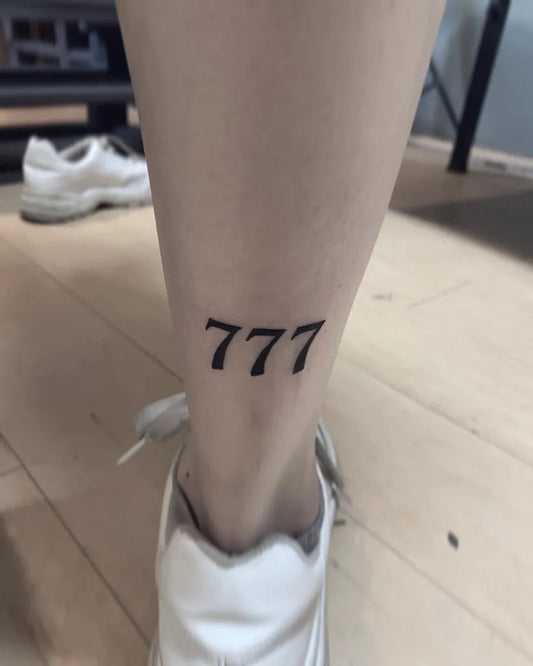Small Blackwork 777 Tattoo on Women Ankle by @maryruiztattoo